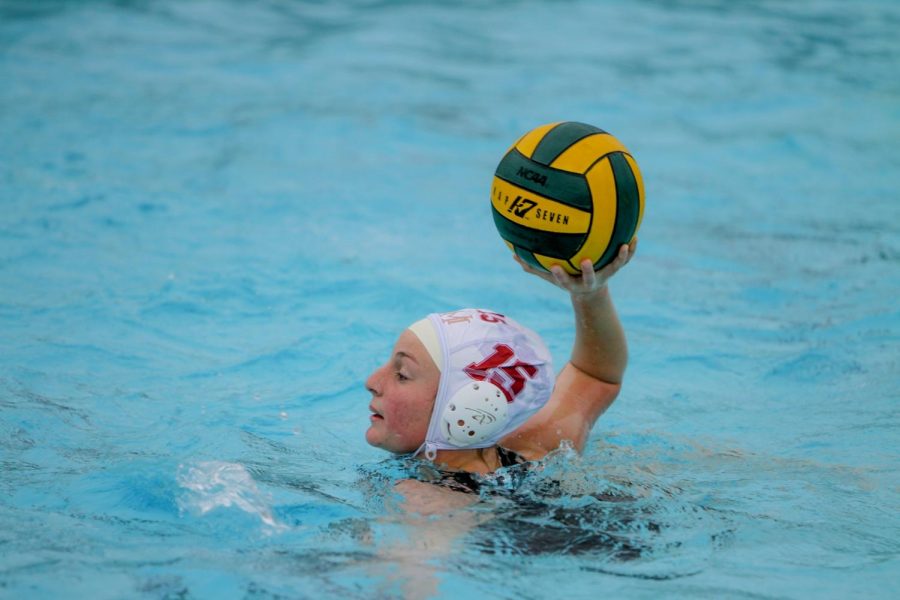 Lacey Pennock (12) searches the pool for an open player.