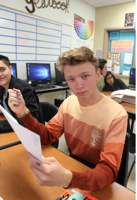 Senior Will Seykora (12) exercises one of many democratic acts as he registers to vote during his AP Government class.