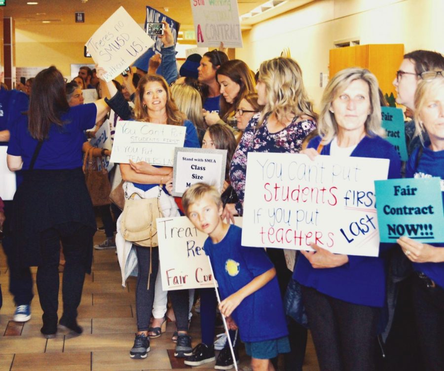 Protesters line up and advocate for higher-quality classroom sizes and an efficient and honest contract at the SMUSD board meeting last month.