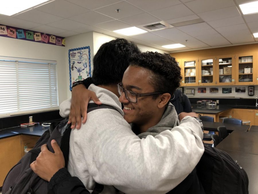 DAndre Jorge (11) and Jayce Jovero (11) dismiss the stigma surrounding male affection as they share a friendly embrace.