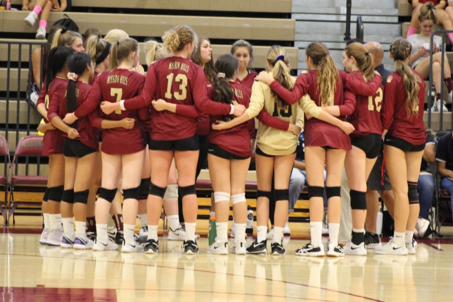 The varsity volleyball girls embrace as a team and prepare to head on the court for their game against La Costa Canyon.