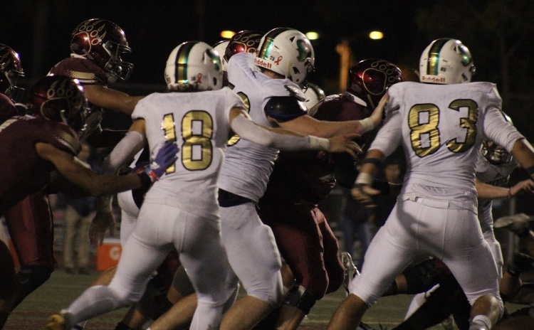 A grizzly heads for a touchdown as La Costa Canyon Mavericks chase him for a tackle at the football home game last Friday.