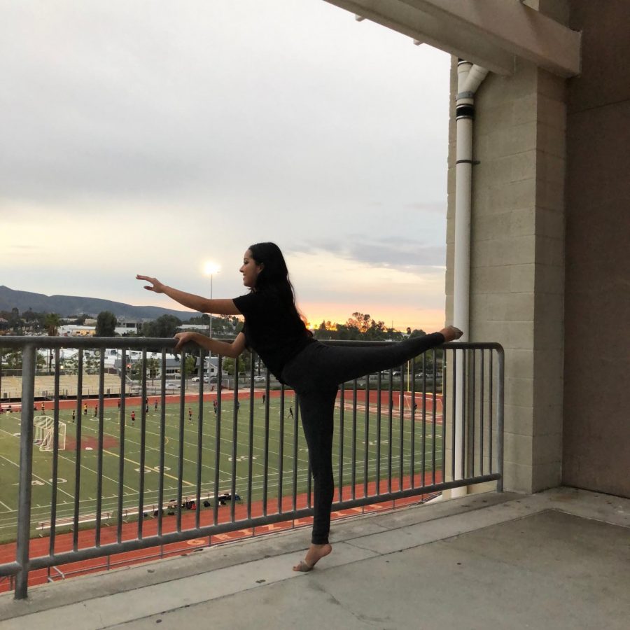 Noemi Aguilar (12) stretching in front of the sunset.