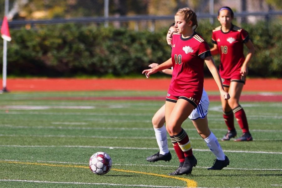 Nicole Rich (12) prepares to pass the ball off to her teammate in a game against Central High School.  