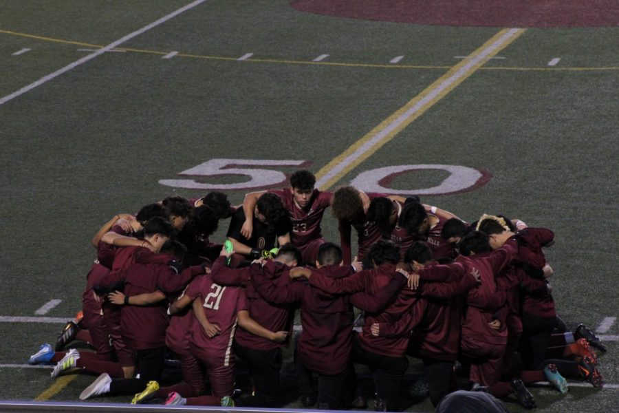 The team prays for a safe, successful game as they face Canyon Crest on Jan. 21st. This is a tradition that the boys built over their season. 