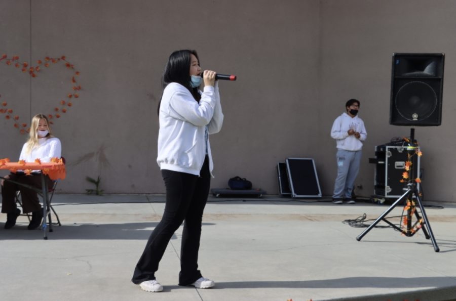 A student on stage at the MHHS amphitheatre during the fall poetry slam