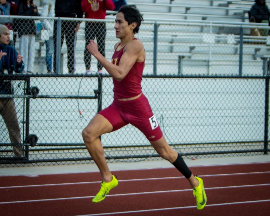 Junior Christian Magana sprinting in first place for the Grizzlies 