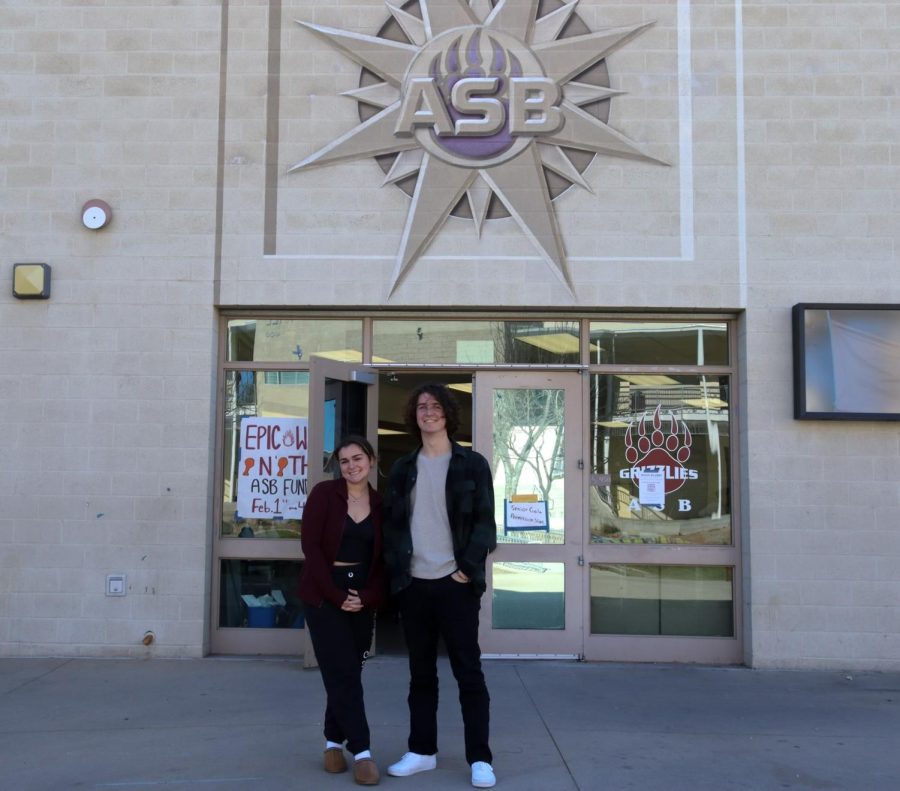 Seniors Kylie Rodal and Ryan Finley stand in front of the ASB room.