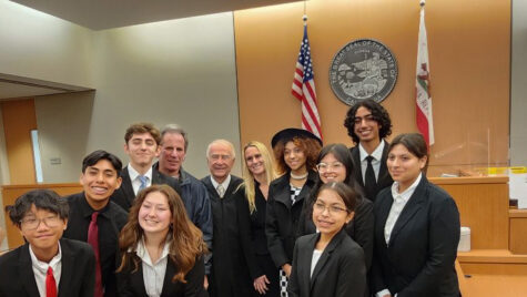 The Mock Trial Prosecution team, posing with the judge who presided over their round 4 presentation with their attorney coaches, Keith Rutman and Kalli Sarkin.