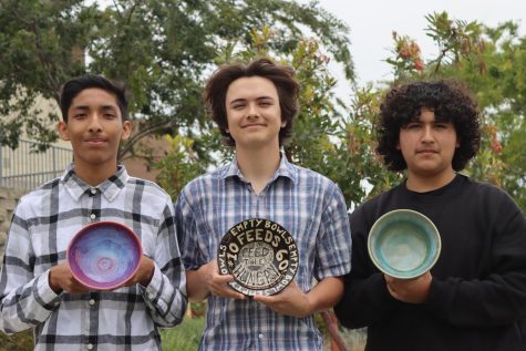 Adriel Bibano, Cameron Angeles and Emmanuel Guillen (left to right) present bowls that will be featured at the Empty Bowls Fundraiser.