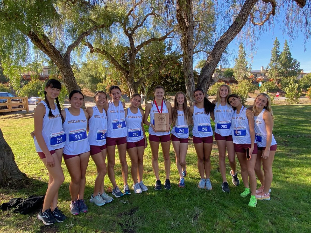 MHHS girls varsity cross country team holds their winning plaque at the league championships.