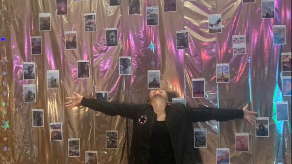 Belen Novelo basking in the energy of the Taylor Swift backdrop, contained with Polaroids of her top songs through The Eras.