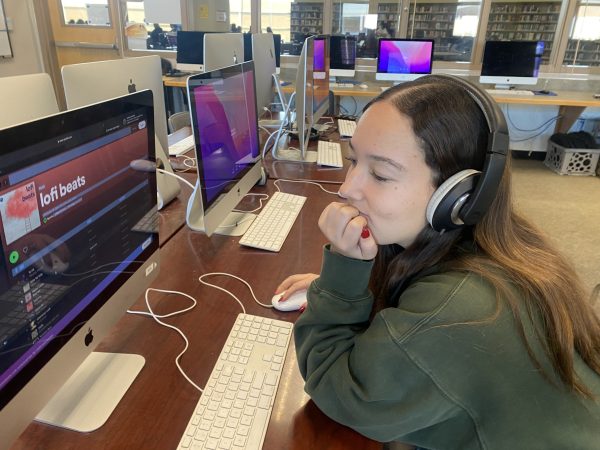 Maddy Donlon picks a playlist to listen to while focusing on her work.