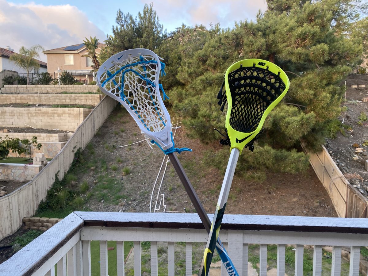 Girls lacrosse stick (left) and boys lacrosse stick (right) held together to show the visual differences