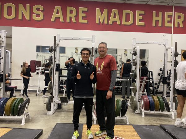 Head Track and Field Coach Hector Menchaca with senior Joel Ras in the weight room after finishing a tough workout on the track.