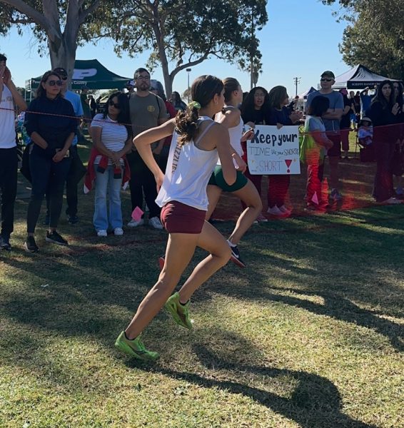Dahlia Valencia sprints at the finish of the CIF Cross Country race.