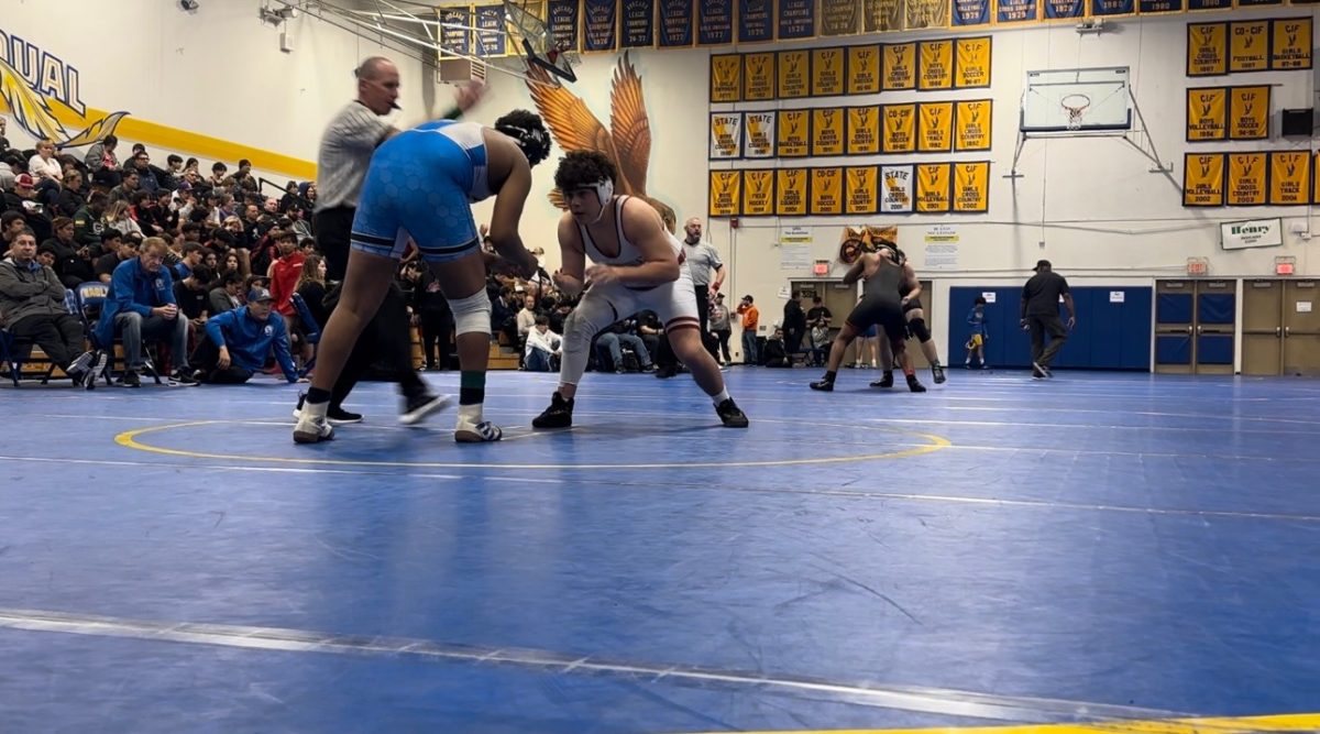 Manny+Kothe%2C+in+white%2C+wrestles+a+difficult+match+that+tests+his+skills+and+wins+the+match+at+San+Pasqual.+He+was+very+proud+of+this+match+because+his+opponent+was+tough+to+beat.+Manny+puts+in+an+incredible+amount+of+effort+into+practice+and+matches%2C+Jim+Kothe+said.