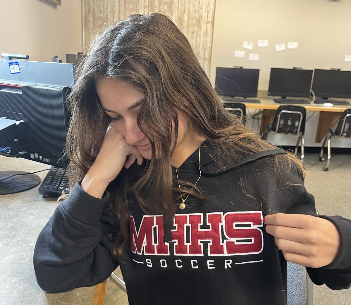 Payton Aleksandrian shows off her MHHS soccer hoodie as she plays on the freshman soccer team. She loves her sport but the unavailable trainer makes her question her safety on the field.  I wish we had a stable trainer so I know I can give my all on the field.