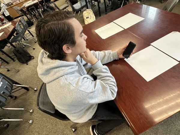 Senior Cole Khayat reads the news on his phone. He always stays aware of biases and false information. For example, during the height of the pandemic, lots of misinformation was going around. I know that many news companies spread different information about vaccines which can lead to misinformation, Khayat said.