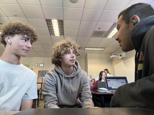 Dane Hanlon, Jude Poyuzina, and Sammy Francisco debating the best way to go about a science project for a good grade. How should we format the slides for the project? Dane said.