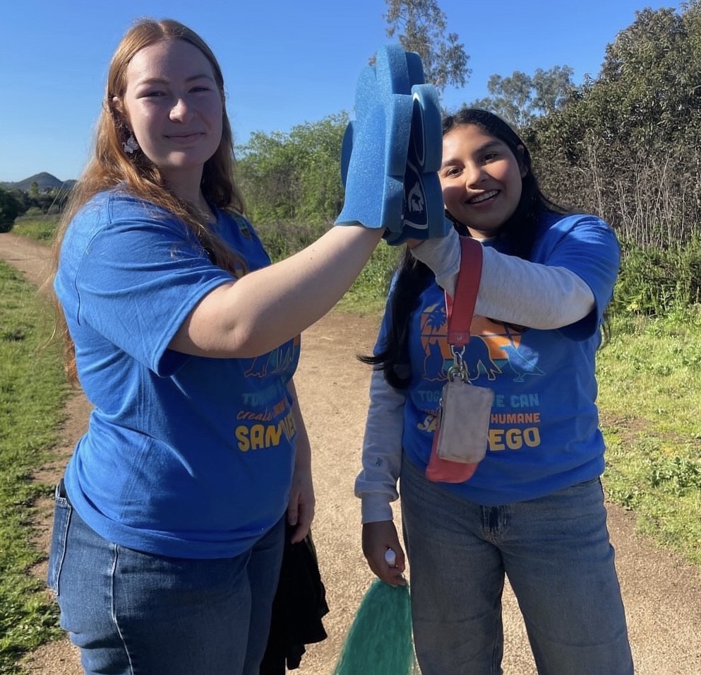Members of the Helping Paws club show club spirit after volunteering. They are volunteering to help animals go into better homes. We enjoy being able to help animals that are struggling or need help,junior Mayte Morales said.