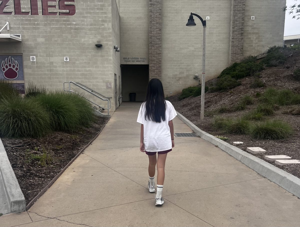 Talia Roberts is pictured after P.E. walking into the locker room. She was going to change her P.E. clothes. I like the fit of my P.E. shirt, just not the fit of my shorts; theyre too big for me, said freshman Roberts.