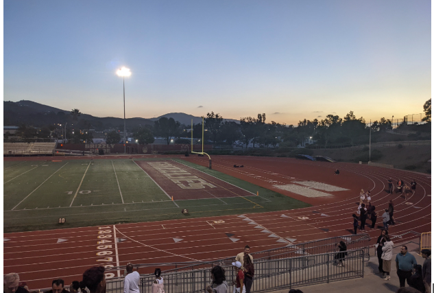 The sun sets over a Friday night football game, one of the classic high school experiences. Friday night football games are really fun and its a great way to build community with your school, said Simone Soricelli.