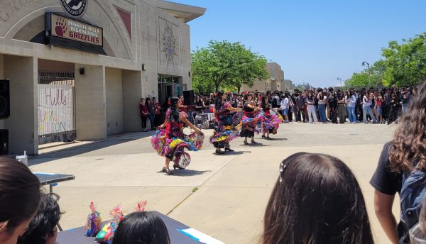 The Baile Folklórico Club performs a vibrant dance. Students from MHHS gather around during the Mission Hills Cultural  Folklórico event at lunch, May 29, 2024. The Balie Folklórico Club members are volunteering their time to showcase traditional dance, adding cultural flair to the school event. “Volunteering is the heartbeat of our community; it brings us together and showcases the beautiful diversity within our school,” senior Remy Escobar said.