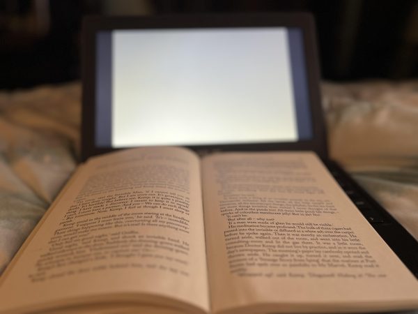 A visual comparison between the pages of a book and the screen of a computer is represented. Technology has been influencing each part of society, including the most common ways to consume entertainment. Wheres the humanity in checking out books online? senior Kylie Schultz said.